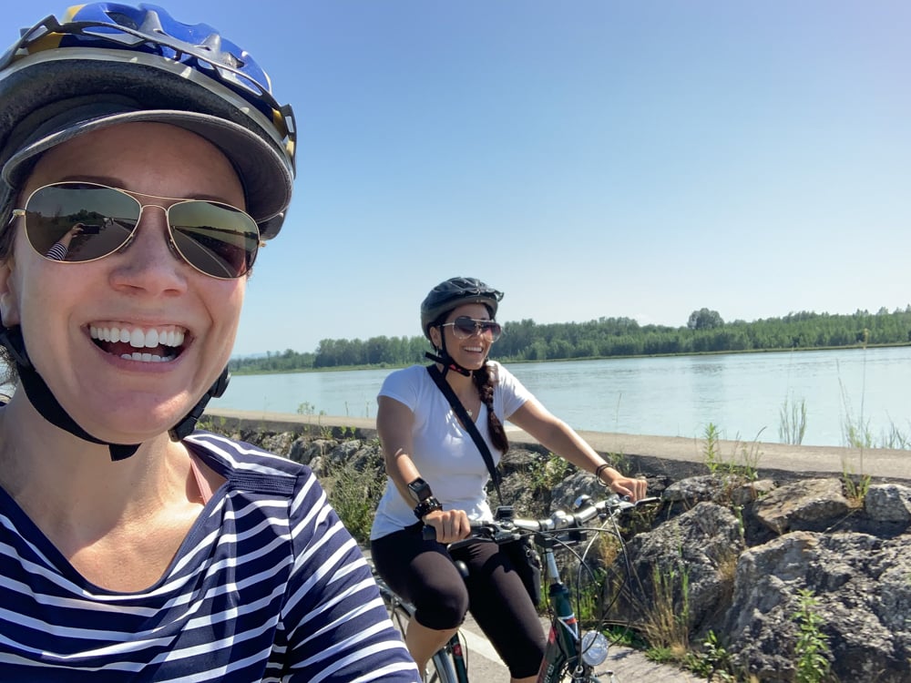 Rachelle and friend riding bikes along the Danube River
