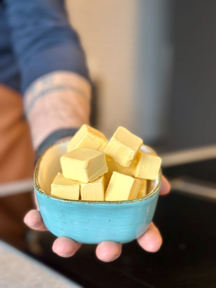 blue bowl full of cubed butter