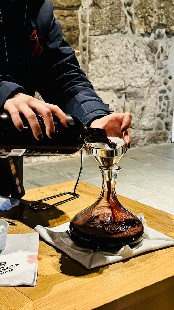 Pouring an old port through a filter into a decanter.