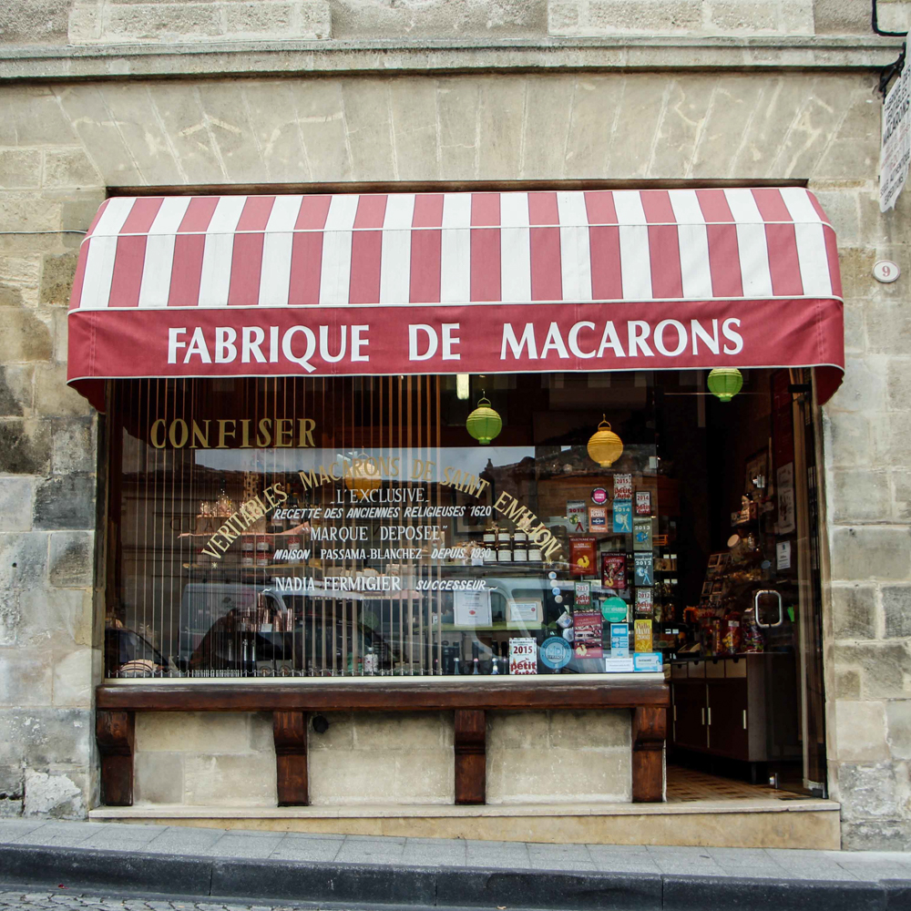 Fabrique de Macarons storefront with red and white awning