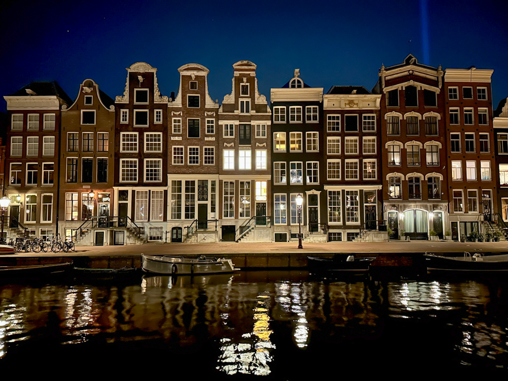 Amsterdam canal and row houses at night.