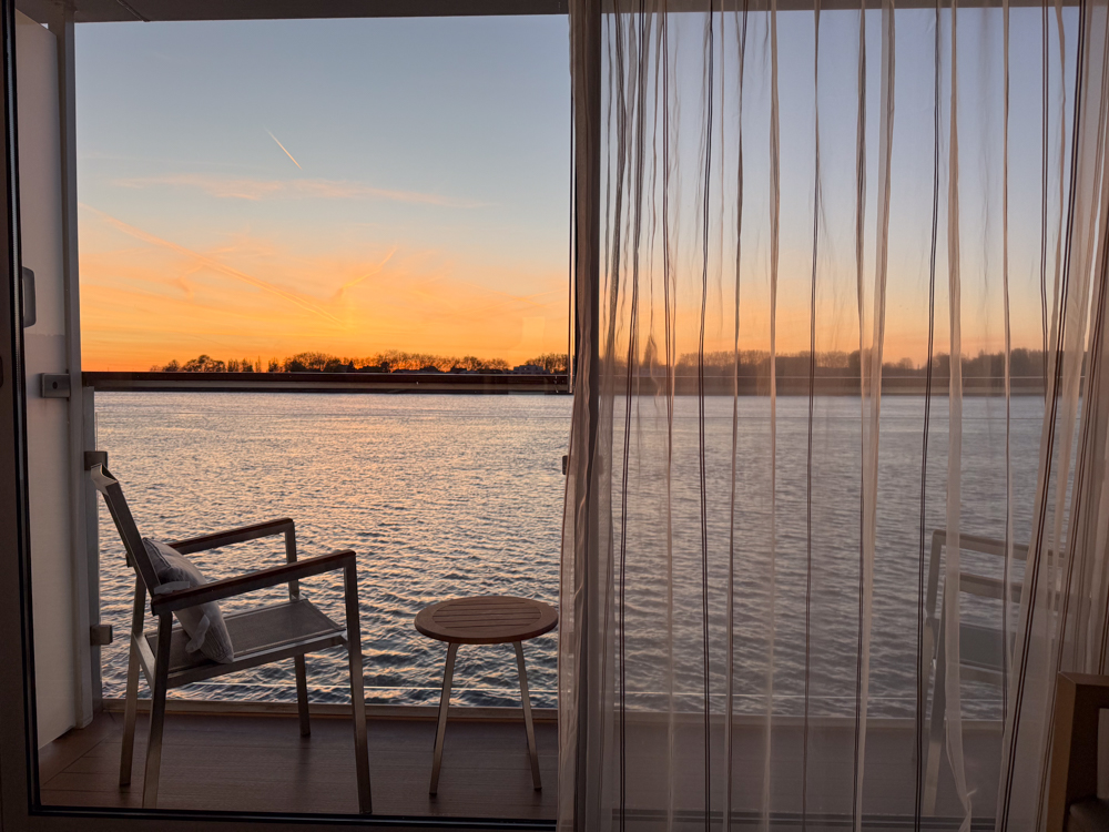 Sunset view of river off balcony in Viking River Cruise cabin