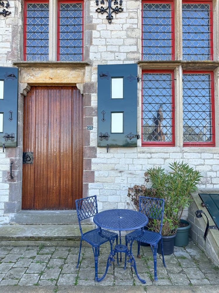 Blue cafe table next to medieval building