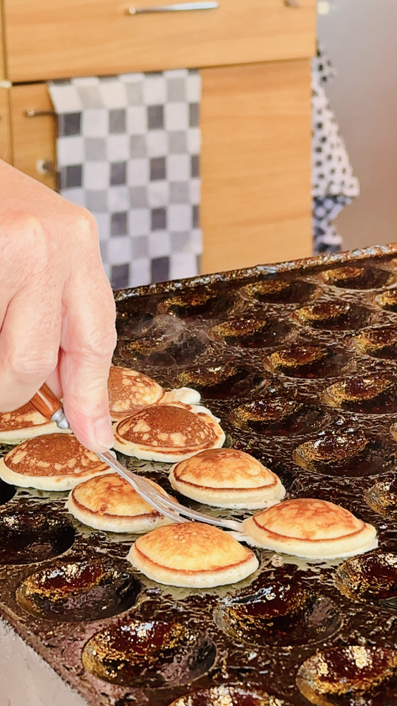 street vendor flipping proffertjes (mini Dutch pancakes)