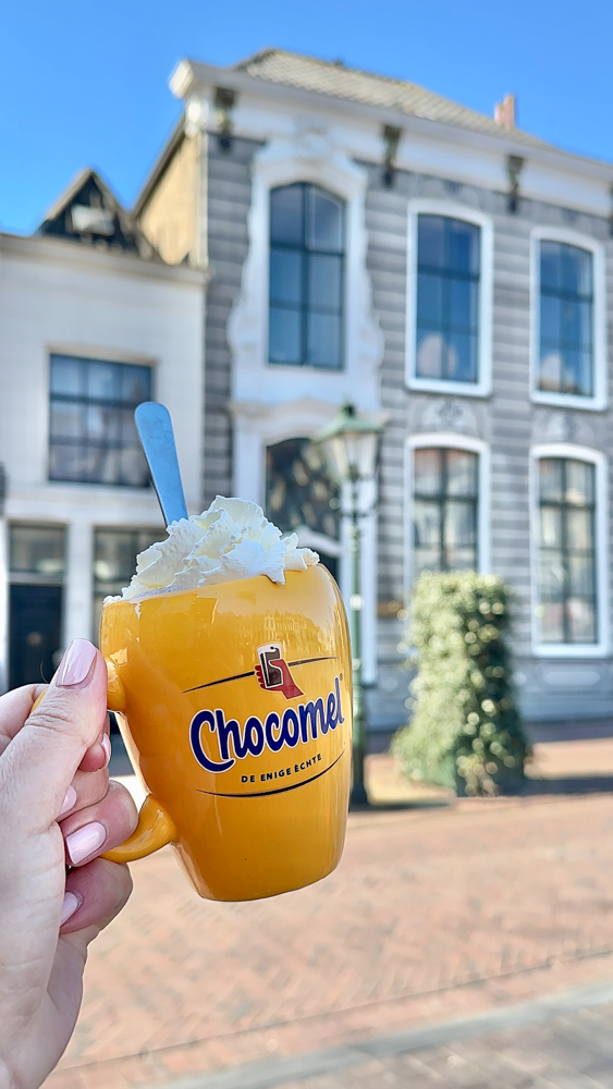Rachelle holding up a hot chocolate in Zierikzee