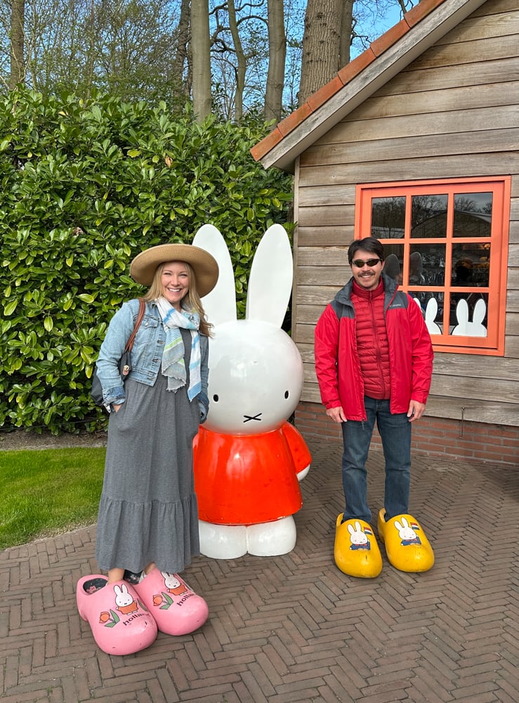 Rachelle and Pete standing in giant dutch shoes next to Miffy