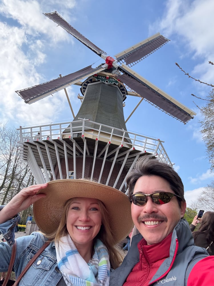 Rachelle and Pete under a windmill in Keukenhof Gardens