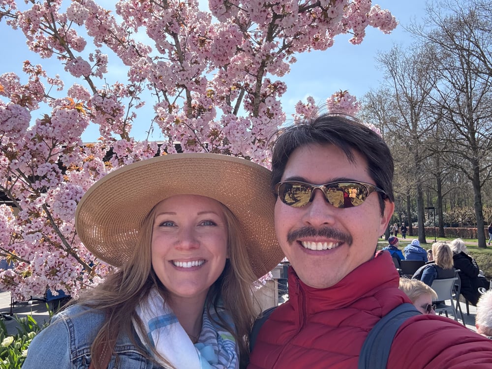Rachelle and Pete under pink blossom tree