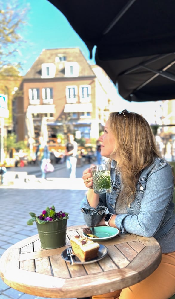 Rachelle sipping mint tea at a cafe table