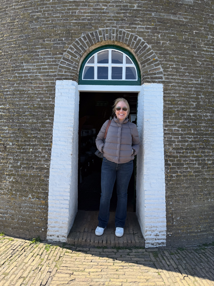 Rachelle standing in the doorway of a windmill