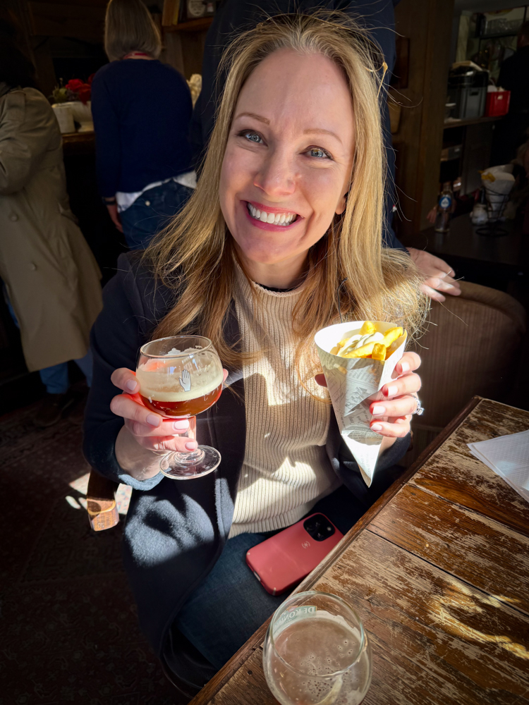 Rachelle with beer and fries on a Belgian Food Tour
