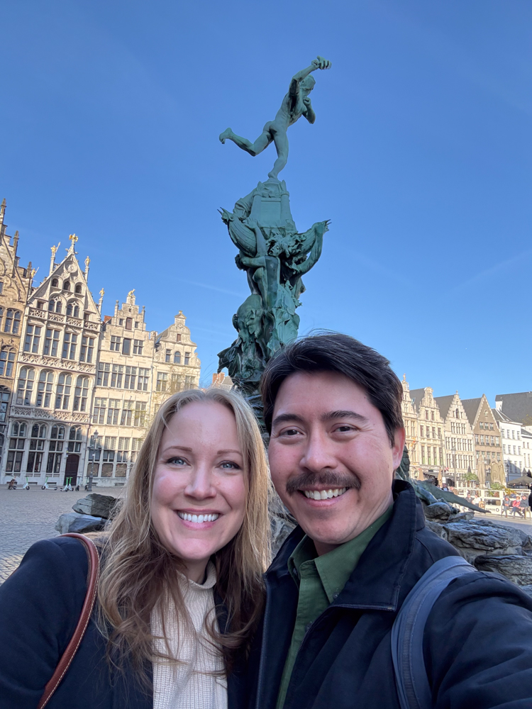 Rachelle and Pete standing next to a fountain in Antwerp